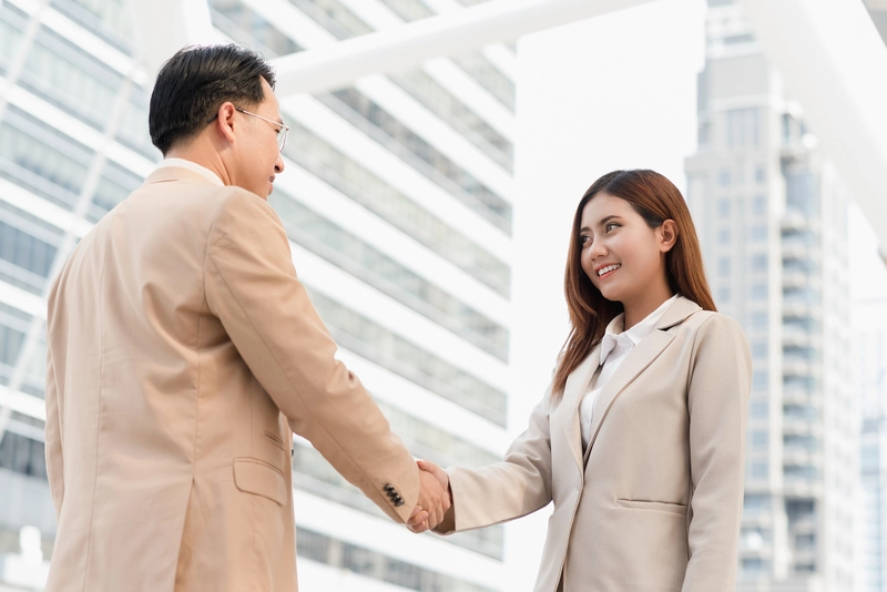 Project management company formalising a project partnership during a business meeting